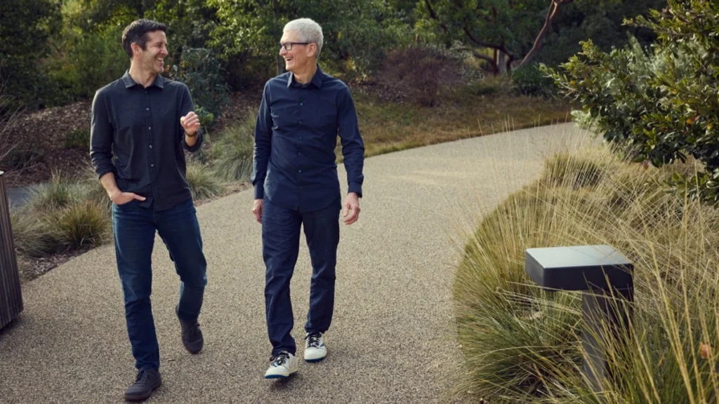 John Ternus and Tim Cook walking together at Apple Park